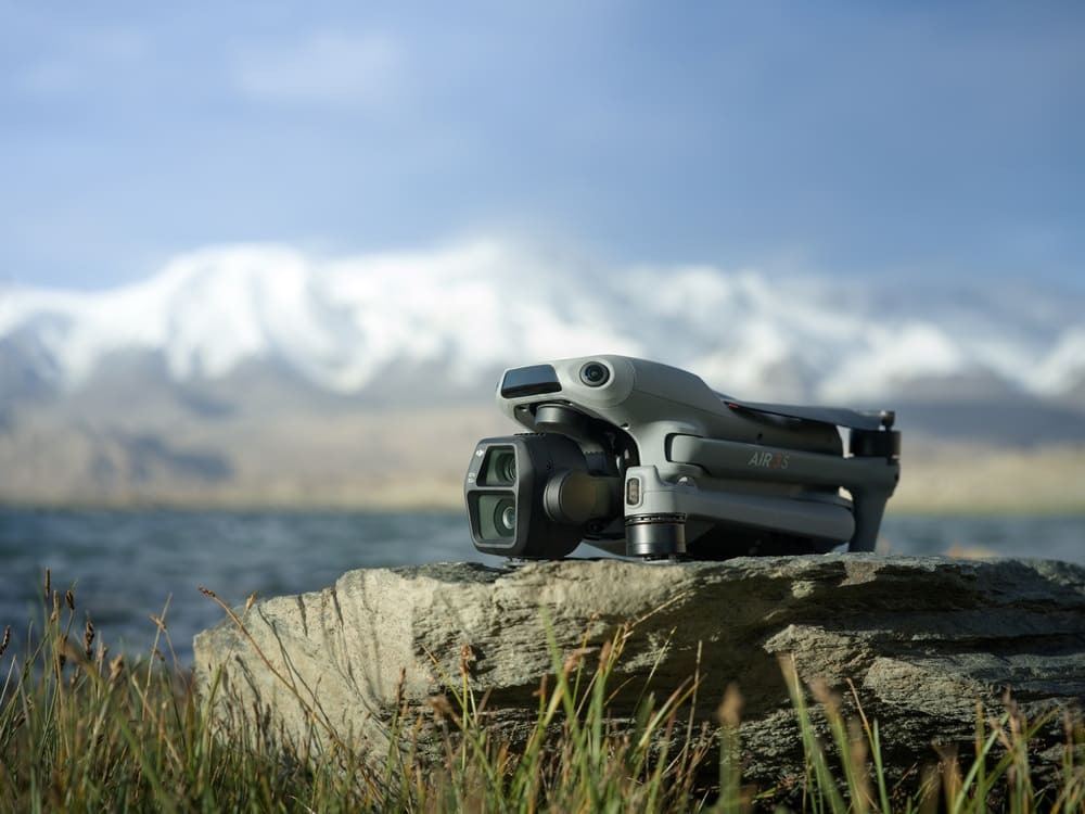 Best Drones for Real Estate Photography : DJI Air 3 series drone on a rock