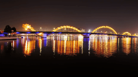 Night timelapse preview—bridge lights reflecting on calm water (hero clip).