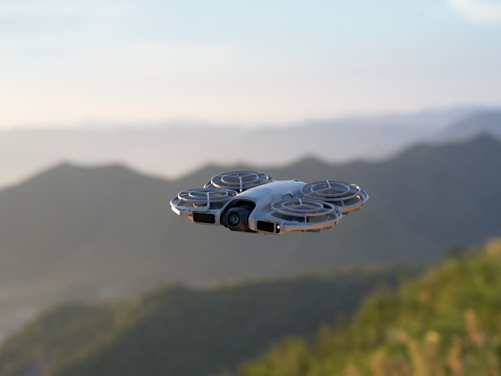 Best Drones Under 300 Euro - DJI Neo 2 Hovering on a mountain Landscape