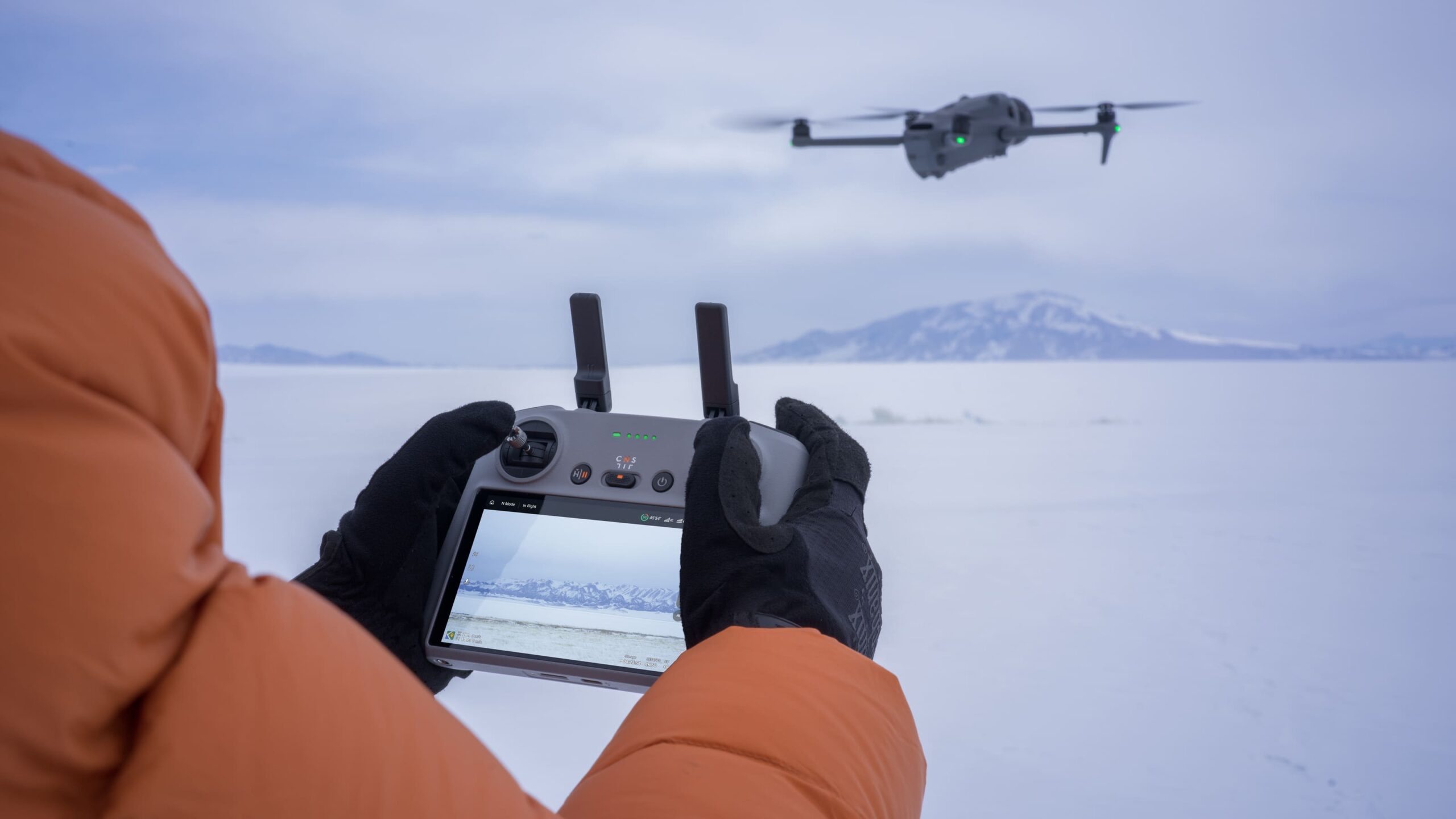 Best Professional Drones 2026 - Hero - A professional Drone pilot with a screen controller flying a mavic 4 Pro Drone